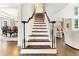 Grand foyer with staircase featuring hardwood floors and abundant natural light at 3456 Glen Mist Pl, Dacula, GA 30019