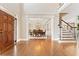 Bright foyer with hardwood floors, staircase, and open access to formal dining room at 3456 Glen Mist Pl, Dacula, GA 30019