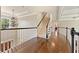 Hallway features stairs, hardwood floors, and natural light at 3456 Glen Mist Pl, Dacula, GA 30019