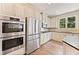 Modern kitchen featuring stainless steel appliances, double ovens, and white cabinetry at 3456 Glen Mist Pl, Dacula, GA 30019