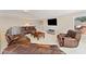 Comfortable living room with plush leather seating, TV and a view of the backyard at 3456 Glen Mist Pl, Dacula, GA 30019