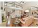 Grand living room featuring a fireplace, wood floors, and a second-floor balcony at 3456 Glen Mist Pl, Dacula, GA 30019