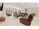 Spacious living room with plush, theater seating and ample natural light at 3456 Glen Mist Pl, Dacula, GA 30019