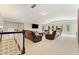 Upstairs living room features comfortable seating, large-screen TV, and windows at 3456 Glen Mist Pl, Dacula, GA 30019