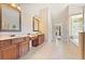 Main bathroom boasts dual sink vanities, tile floors, and soaking tub at 3456 Glen Mist Pl, Dacula, GA 30019