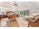 Inviting primary bedroom with a trey ceiling, sitting area, and natural light at 3456 Glen Mist Pl, Dacula, GA 30019