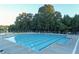 Large community pool with lane markers surrounded by lounge chairs at 3456 Glen Mist Pl, Dacula, GA 30019