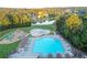 Aerial view showcasing the neighborhood pool, kiddie splashpad, playground and serene lake at 3456 Glen Mist Pl, Dacula, GA 30019