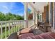 Inviting front porch area with cushioned wicker seating and outdoor lighting at 3456 Glen Mist Pl, Dacula, GA 30019