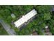 Aerial view of building with a parking lot and pool surrounded by trees at 107 Ridley Howard Ct, Decatur, GA 30030