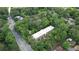 Aerial view of building with a community pool surrounded by trees and nearby roads at 107 Ridley Howard Ct, Decatur, GA 30030