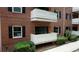 Balconies with white railings, brick exterior, and black shutters add charm to this condo at 107 Ridley Howard Ct, Decatur, GA 30030