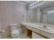 Bright bathroom featuring a single sink vanity, a standard toilet, and a framed mirror with vanity lighting at 107 Ridley Howard Ct, Decatur, GA 30030