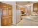 Traditional kitchen with wood cabinets, white appliances, and breakfast bar provides a functional space at 107 Ridley Howard Ct, Decatur, GA 30030