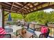 Inviting back deck with comfortable seating, grill, and views of the surrounding trees at 1560 Gilstrap Nw Ln, Atlanta, GA 30318