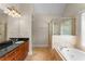 Bright bathroom with soaking tub, glass shower, and dual vanity with granite countertop at 1560 Gilstrap Nw Ln, Atlanta, GA 30318