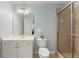 Bathroom featuring a single sink vanity, a glass-enclosed shower, and a neutral color palette at 1560 Gilstrap Nw Ln, Atlanta, GA 30318