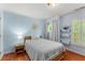 Comfortable bedroom with hardwood floors, round window and plantation shutters at 1560 Gilstrap Nw Ln, Atlanta, GA 30318