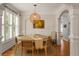 Bright dining room with a round table, stylish chairs, and modern light fixture at 1560 Gilstrap Nw Ln, Atlanta, GA 30318