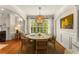 Bright dining room featuring a round table, woven light fixture, and elegant wainscoting at 1560 Gilstrap Nw Ln, Atlanta, GA 30318