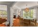 Open-concept dining area with hardwood floors, fireplace, and views into the living room at 1560 Gilstrap Nw Ln, Atlanta, GA 30318