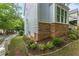 Charming home exterior with light blue siding and stone accents, complemented by manicured landscaping at 1560 Gilstrap Nw Ln, Atlanta, GA 30318