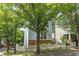 Inviting two-story home with a white picket fence and lush green trees at 1560 Gilstrap Nw Ln, Atlanta, GA 30318