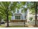 Charming two-story home with light blue siding, stone accents, and a white picket fence at 1560 Gilstrap Nw Ln, Atlanta, GA 30318