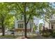 Inviting two-story home with light blue siding, stone accents, and mature trees at 1560 Gilstrap Nw Ln, Atlanta, GA 30318