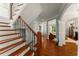 Elegant foyer with hardwood floors, staircase, and arched doorway leading to the living area at 1560 Gilstrap Nw Ln, Atlanta, GA 30318