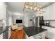 Open-concept kitchen with stainless appliances, island seating, and view of living area with TV at 1560 Gilstrap Nw Ln, Atlanta, GA 30318