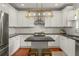 Well-lit kitchen features stainless appliances, white cabinets, granite countertops, and central island at 1560 Gilstrap Nw Ln, Atlanta, GA 30318