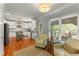 Bright kitchen with white cabinetry, stainless appliances, and cozy seating area near a window at 1560 Gilstrap Nw Ln, Atlanta, GA 30318