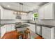 Updated kitchen with white cabinets, granite countertops, stainless steel appliances, and island seating at 1560 Gilstrap Nw Ln, Atlanta, GA 30318