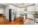 Modern kitchen with stainless steel appliances, white cabinets, and a stylish kitchen island at 1560 Gilstrap Nw Ln, Atlanta, GA 30318