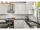 Updated kitchen featuring white cabinets, stainless steel appliances, and stylish backsplash at 1560 Gilstrap Nw Ln, Atlanta, GA 30318