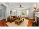 Comfortable living room with hardwood floors, coffered ceiling, and a brown leather sofa at 1560 Gilstrap Nw Ln, Atlanta, GA 30318