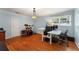 Spacious room with hardwood floors, a drum set, and a work area illuminated by a window at 1560 Gilstrap Nw Ln, Atlanta, GA 30318
