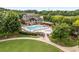 A refreshing swimming pool with lounge chairs and covered patios surrounded by lush trees in a community setting at 1560 Gilstrap Nw Ln, Atlanta, GA 30318