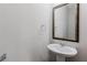Elegant half bathroom with pedestal sink and decorative mirror for added style at 2089 Lanier Harbor Pt # 2089, Buford, GA 30518