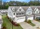 Aerial view showcasing the beautiful landscaping of this well-maintained two-story townhome community at 2089 Lanier Harbor Pt # 2089, Buford, GA 30518