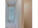 Light-filled hallway with neutral carpet and access to various rooms in the house at 2089 Lanier Harbor Pt # 2089, Buford, GA 30518