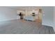 Open-concept living room and kitchen area with stainless steel appliances and grey wood-look floors at 2089 Lanier Harbor Pt # 2089, Buford, GA 30518
