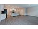 Bright and open-concept living area with grey wood-look floors adjacent to the kitchen at 2089 Lanier Harbor Pt # 2089, Buford, GA 30518
