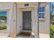 Welcoming front entryway with a dark gray door, brick facade, and a 'Home' welcome mat at 2364 Haran Dr # 35, Lithonia, GA 30058