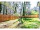 Large fenced backyard with lush green grass, perfect for outdoor activities and privacy at 1105 Gun Club Nw Rd, Atlanta, GA 30318
