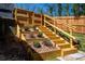 Tiered wooden staircase with built-in planters, adding character and functionality to the outdoor space at 1105 Gun Club Nw Rd, Atlanta, GA 30318
