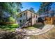 Rear exterior of home with staircase and stone pathway, surrounded by well-maintained landscaping at 1105 Gun Club Nw Rd, Atlanta, GA 30318