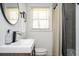 Modern bathroom features a vessel sink, updated fixtures, and a tiled shower with neutral toned shower curtain at 1105 Gun Club Nw Rd, Atlanta, GA 30318