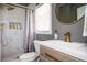 Upgraded bathroom with rainfall shower head, tiled walls, a storage shelf, and modern vanity at 1105 Gun Club Nw Rd, Atlanta, GA 30318